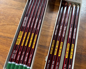 May include: A box of 12 green Koh-I-Noor pencils, labeled "KOH-IN-ALL" and "No. 1555", and a box of 12 red Koh-I-Noor pencils, labeled "KOH-IN-ALL" and "No. 1555".