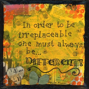 May include: Mixed media art piece with a black frame. The yellow background features text that reads "In order to be irreplaceable one must always be... DIFFERENT!". Includes a heart, butterfly, and vintage ephemera.