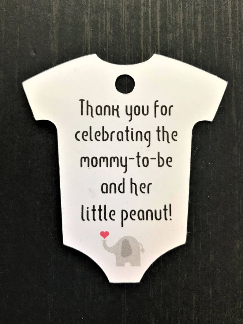 May include: White baby onesie shaped thank you tag with a gray elephant holding a red heart. The tag says "Thank you for celebrating the mommy-to-be and her little peanut!"