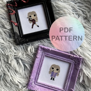 May include: Two framed cross-stitch patterns of a cartoon girl in different outfits. The first frame is black and the second frame is purple. The text "PDF PATTERN" is on a rainbow gradient background.