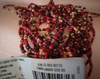 250 inch strand of amber shades of seed beads