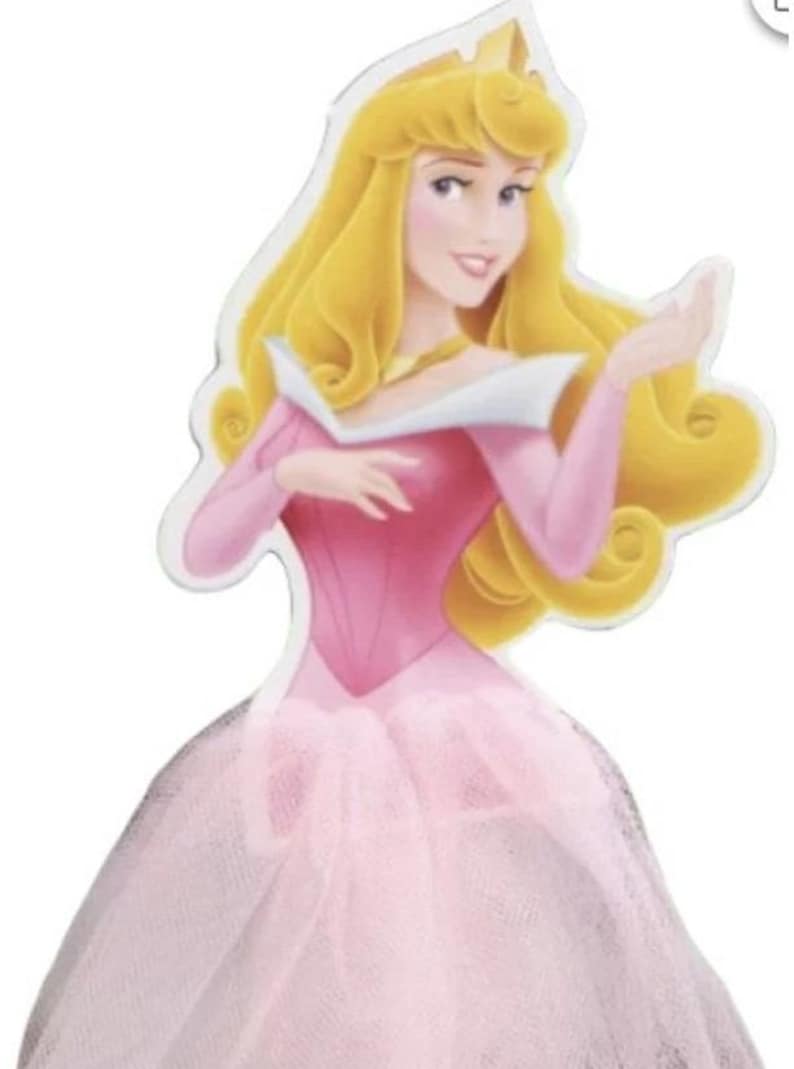 May include: A die-cut image of Princess Aurora from Disney's Sleeping Beauty. She is depicted with long, flowing blonde hair, wearing a pink gown with a tulle skirt and a gold crown. The image has a white border.