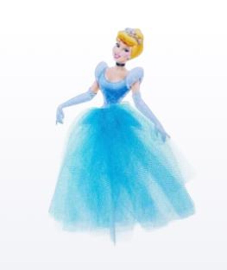 May include: A Cinderella figurine in a light blue ball gown with a tulle skirt, matching gloves, and a choker. The doll has blonde hair styled in a bun and a tiara. The figurine is posed with arms outstretched.