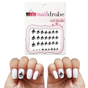 May include: Black and white nail decals featuring a silhouette of a horse and rider. The decals are on a white sheet with the text "naildrobe nail decals".
