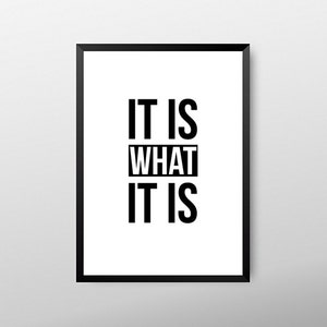 May include: Framed wall art with the phrase "IT IS WHAT IT IS" in bold, black capital letters on a white background. The artwork is encased in a black frame, suitable for home or office decor.