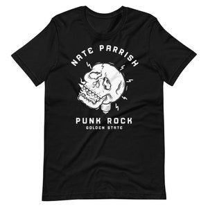 May include: Black t-shirt with a white graphic of a skull inside a lightbulb with the text "Nate Parrish Punk Rock Golden State".