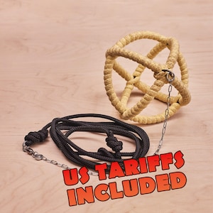 May include: A spherical cage structure crafted from thick, light yellow rope, connected by a thin silver-toned metal chain to a coiled length of black rope. The image features the bold red text US TARIFFS INCLUDED at the bottom.