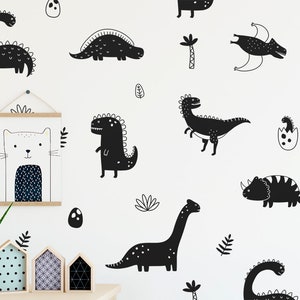 May include: Black and white dinosaur wall decals featuring various dinosaur silhouettes, including a stegosaurus, triceratops, and a pterodactyl. The decals are perfect for adding a playful touch to a child's room.