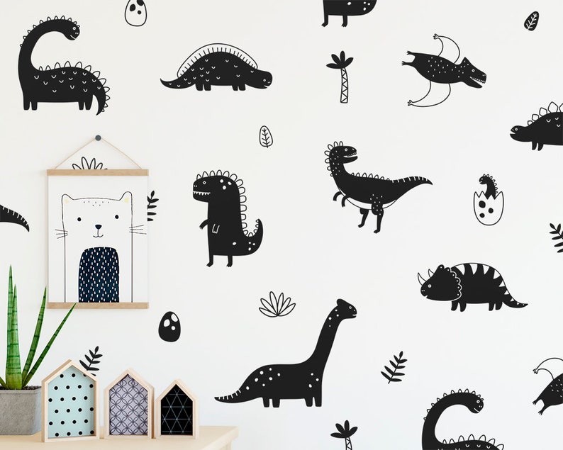 May include: Black and white dinosaur wall decals featuring various dinosaur silhouettes, including a stegosaurus, triceratops, and a pterodactyl. The decals are perfect for adding a playful touch to a child's room.