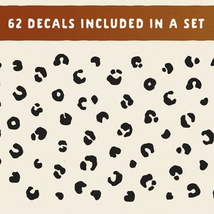 May include: A set of 62 black leopard print decals. The decals are on a white background.