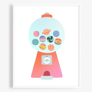 May include: A pastel pink and orange gumball machine with a clear globe filled with colorful gumballs that resemble planets. The gumballs have different patterns and colors, including blue, green, pink, orange, and yellow.