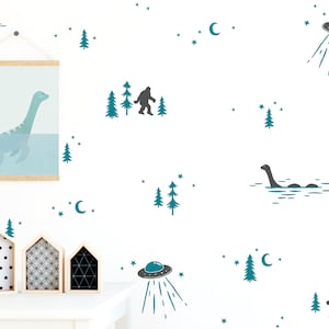 May include: A white wall with teal blue and gray illustrations of a Loch Ness monster, a Bigfoot, a UFO, and a forest. The illustrations are part of a wall decal set.