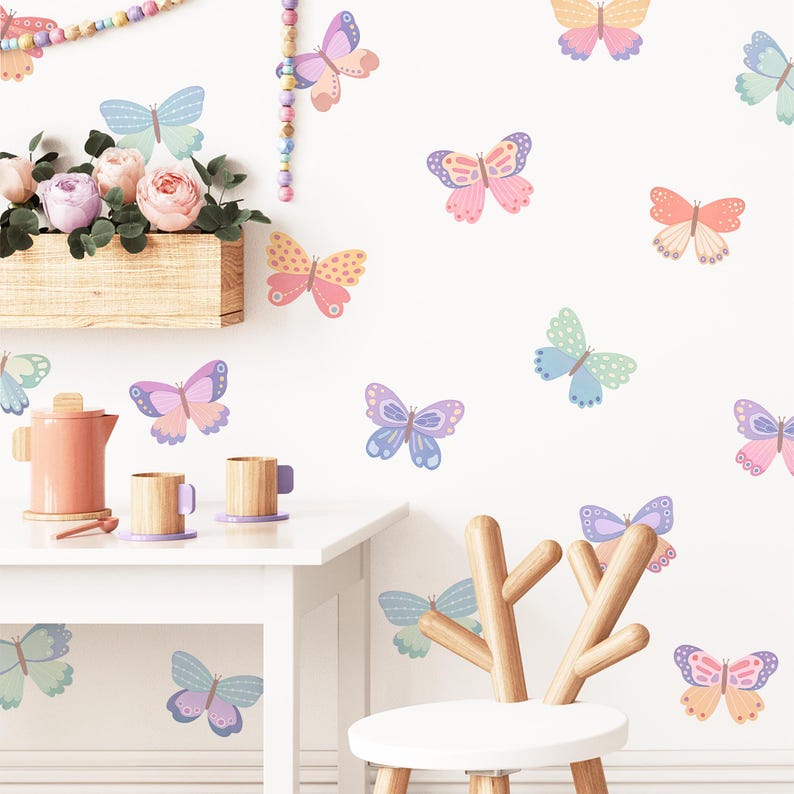 May include: A white wall with colorful butterfly wall decals in various shades of pink, purple, blue, and green. The butterflies are arranged in a random pattern on the wall.