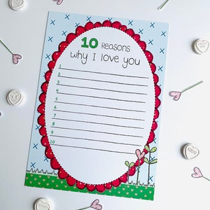 May include: A printable card with a red heart-shaped frame and the text "10 Reasons why I love you" with lines for writing. The card has a green grass border and a blue background with white X's.