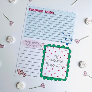 May include: A printable worksheet with a blue and white patterned background. The worksheet has the text "Remember When" and "Things to look forward to:" with lines for writing. There is a green and white frame with the text "My favorite photo of us" and red polka dots.