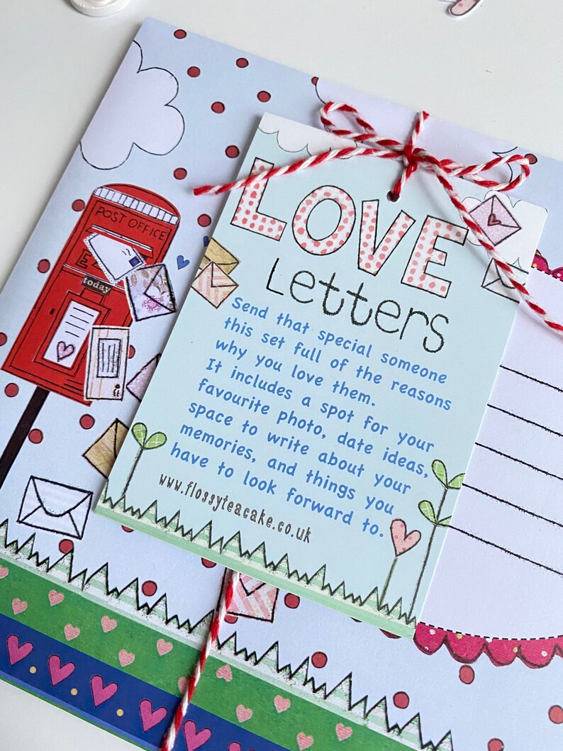May include: A set of blank cards with a red and white string tied around them. The cards are decorated with a red mailbox, hearts, and the text "LOVE Letters". The text on the cards reads "Send that special someone this set full of the reasons why you love them. It includes a spot for your favorite photo, date ideas, space to write about your memories, and things you have to look forward to. www.flossyteacake.co.uk"