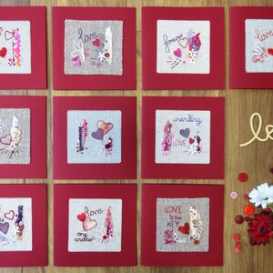 May include: Ten handmade cards with red borders and hessian centres. Each card features a different embroidered design with hearts, feathers, and text. The text on the cards includes "always", "love", "forever", "unending love", "love deeply", "love one another", and "love is the key".