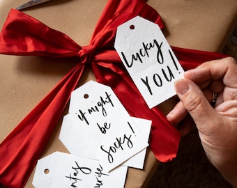 Handwritten Christmas gift tags made from handmade paper with velvet ribbon