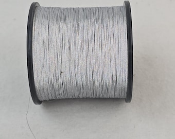 1 spool 200 g reflective yarn  both sides  Nm 8 grey 8.000 m/kg on a flanged bobbine