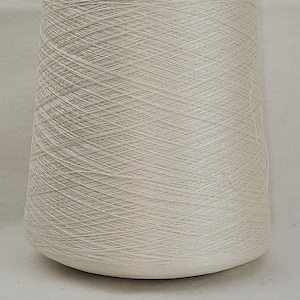 May include: A cone of off-white yarn.