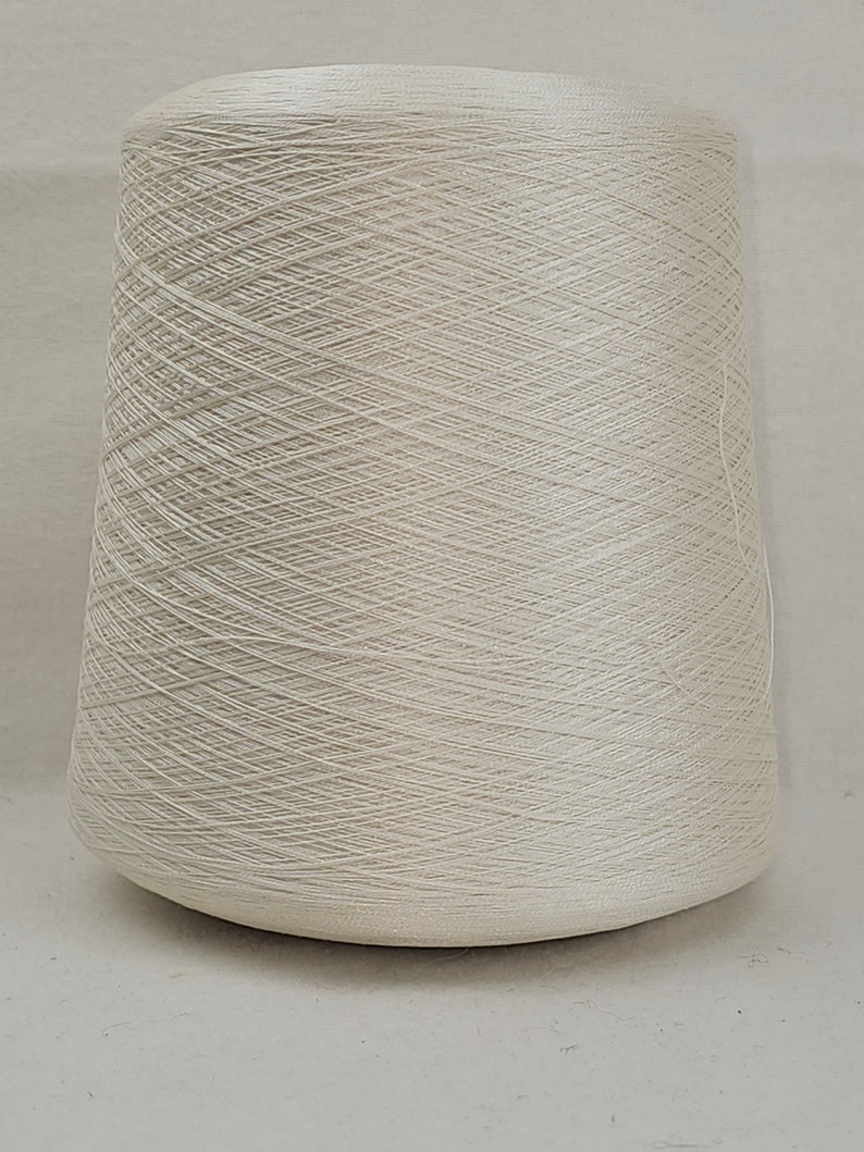 May include: A cone of off-white yarn.