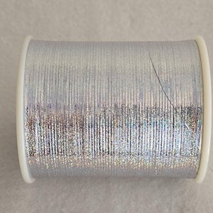 M-Type 1/69 holographisch - silver unsupported Nm 70  lurex yarn metalised flat yarn on flanged bobbine