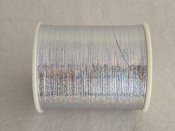 1 Spule 300 g M Type GP 65,00 Euro/ kg holographisch silber unverstärkt Scheibenspule Lurexgarne