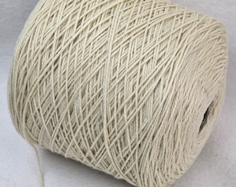 May include: A skein of natural colored yarn wound into a ball. The yarn is made of a natural fiber, possibly cotton or linen.
