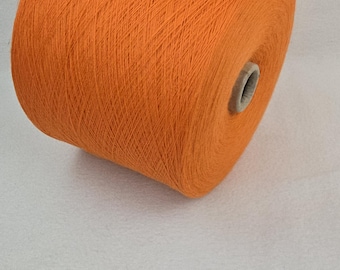 May include: A spool of bright orange yarn.
