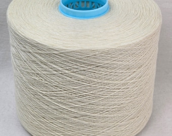 May include: A large spool of white yarn with a blue plastic center.