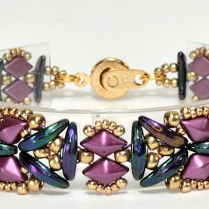 May include: A beaded bracelet with a geometric design featuring purple, gold, and green beads. The bracelet has a magnetic clasp.