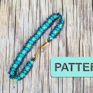 May include: A turquoise, yellow, and black beaded bracelet with a gold clasp. The bracelet is on a wooden surface with the word "PATTERN" printed on a light blue rectangle.