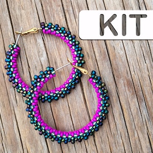 May include: A kit for making beaded earrings. The earrings are made with iridescent blue and pink beads and have gold-toned ear wires.