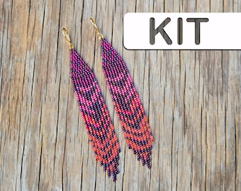 May include: A pair of long, dangling earrings crafted from small beads in shades of purple, magenta, and orange, arranged in a chevron pattern with a fringed bottom edge and gold-tone lever-back hooks. The image includes the text KIT.