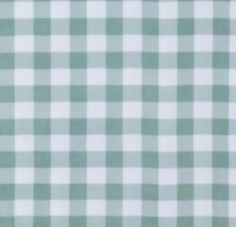 May include: A seamless pattern featuring a classic gingham design. The pattern consists of a grid of alternating squares in a soft, muted green and white color scheme. This fabric design is often used for tablecloths, clothing, and home decor.