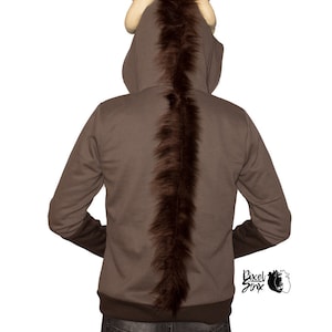 May include: A brown zippered hoodie with a furry brown tail and horns. The hoodie has a brown and white fur hood.
