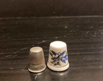 Two Vintage Sewing Thimbles. 1 is a glass  with a Bluebird & the other was made in Germany Metal Size 9