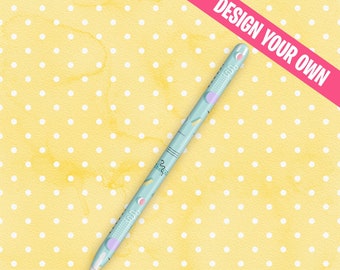 May include: A light blue Apple Pencil skin with a geometric pattern in pink, purple, and teal. The text "DESIGN YOUR OWN CUSTOM APPLE PENCIL SKIN" is at the bottom of the image.
