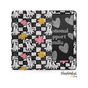 May include: A black and white checkered Kindle cover with a ghost and flower pattern. The cover has a black and white checkered background with white ghosts and pink and yellow flowers. The text on the Kindle screen reads "Emotional Support Kindle".