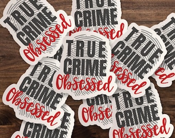 May include: A collection of die-cut stickers featuring a gray fingerprint background with the words TRUE CRIME in bold black block letters and the word Obsessed written in a red cursive script font, layered over one another in a scattered arrangement.