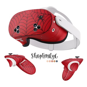 May include: A red and black spider web design VR headset with a white headband and two red and black controllers. The headset features a spider web design with a black spider in the centre. The controllers have a spider web design on the front.
