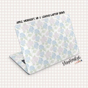 May include: Laptop skin with a floral pattern of blue and pink hydrangeas on a white background. The skin is designed for Apple, Microsoft, HP, and Lenovo laptops. The text "APPLE, MICROSOFT, HP, & LENOVO LAPTOP SKINS" is at the top.