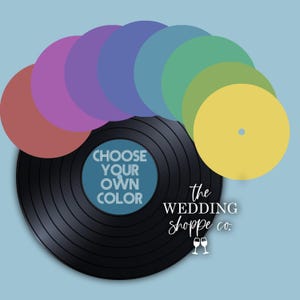 May include: A black vinyl record with a blue centre label featuring the text CHOOSE YOUR OWN COLOR. Above the record, a fan of circular discs in red, purple, violet, blue, teal, green, olive, and yellow. The text the WEDDING shoppe co. is visible.
