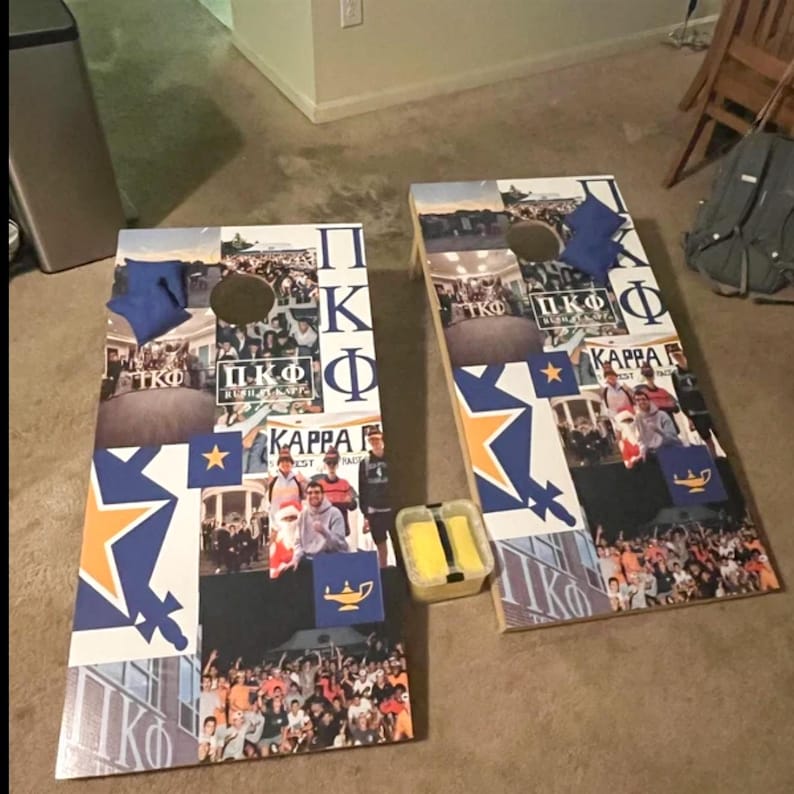 two cornhole boards with various images and text related to Kappa Kappa Psi sorority, including a crowd, a star, and a banner.