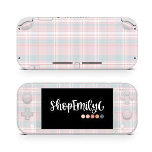 May include: A pastel pink, blue, and white plaid patterned handheld gaming console. The screen displays the text "ShopEmilyG" in white script. The console has buttons and a directional pad.
