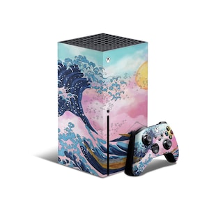 May include: A blue and pink video game console skin with a Japanese wave design. The skin is applied to a white Xbox Series X console and a matching controller. The console and controller are on a white background.
