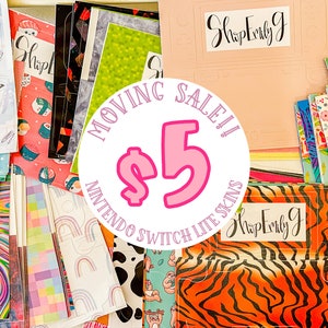 May include: A variety of colorful Nintendo Switch Lite skins are stacked and displayed on a table. The skins feature different patterns, including animal prints, geometric designs, and abstract art. A pink circle with the text "MOVING SALE! $5" is in the center of the image.