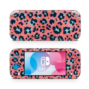 May include: A pink and black leopard print Nintendo Switch console with a blue and pink Joy-Con controller. The console has a screen that displays the Nintendo Switch logo.