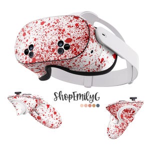 Puede incluir: Auriculares VR blancos con un diseño de pintura salpicada roja y blanca. Los auriculares tienen una correa blanca y dos mandos con el mismo diseño de pintura salpicada.
