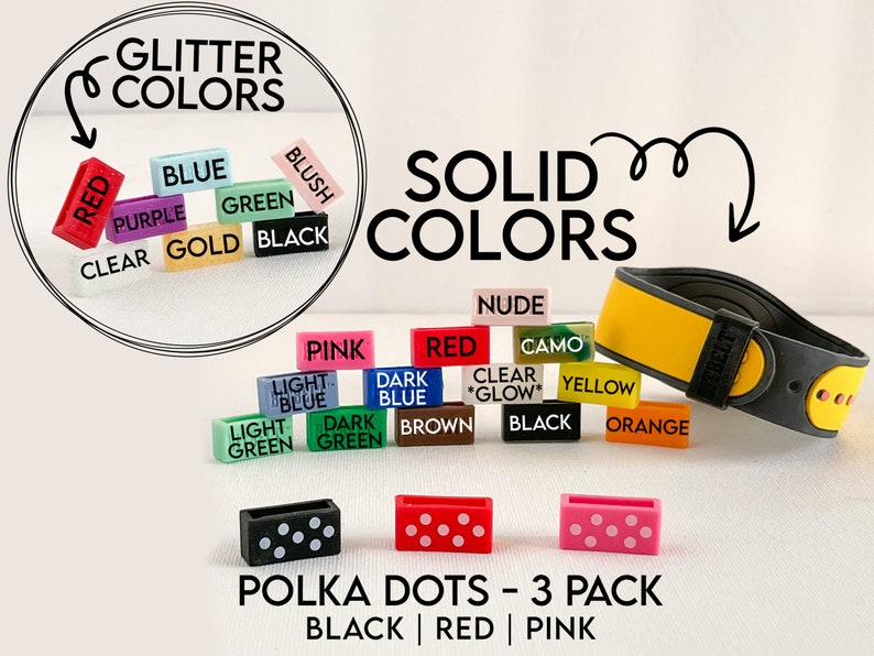 May include: A set of three silicone watch bands with polka dots in black, red, and pink. The bands are shown on a white background with other watch band colours in the background.
